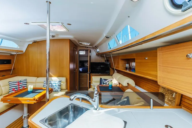 Kia Ora Yacht Photos Pics Interior of 2014 Catalina 385 sailboat with modern kitchen and cozy seating area.