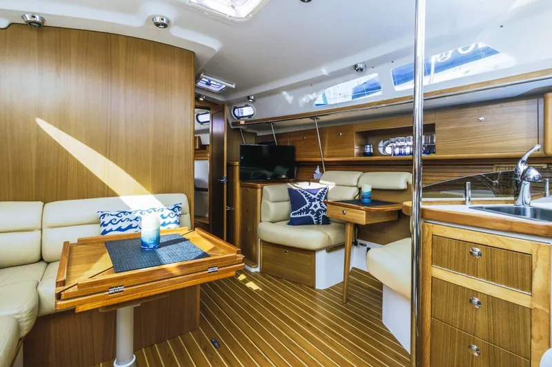 Kia Ora Yacht Photos Pics Luxurious interior of 2014 Catalina 385 sailboat with wood finish and modern amenities.