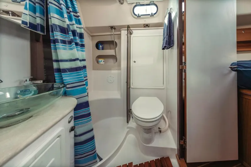 Kia Ora Yacht Photos Pics Catalina 385 2014 yacht bathroom with shower, toilet, and glass sink.