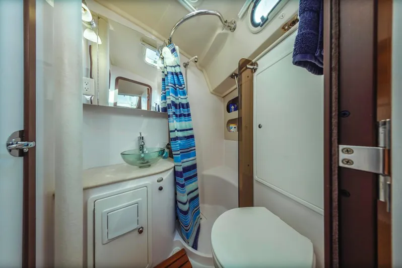 Kia Ora Yacht Photos Pics Compact bathroom in 2014 Catalina 385 sailboat with shower, sink, and toilet.
