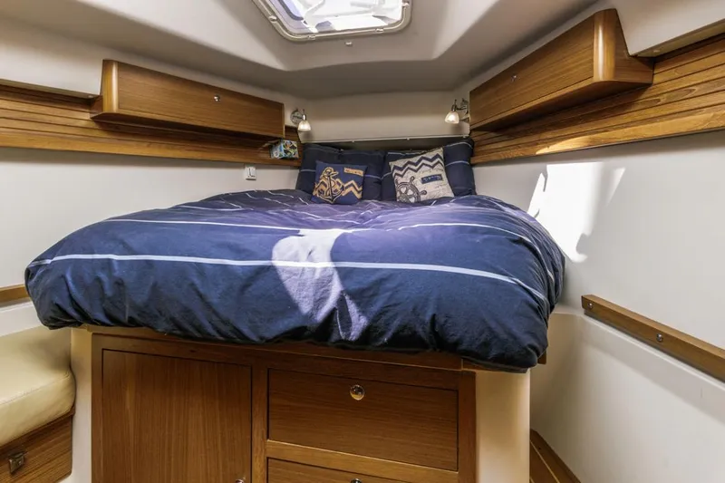 Kia Ora Yacht Photos Pics Cozy cabin interior of 2014 Catalina 385 sailboat with comfortable bedding.