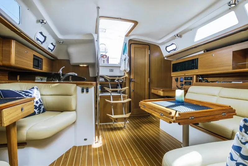 Kia Ora Yacht Photos Pics Interior of 2014 Catalina 385 sailboat with modern wood finish and cozy seating.