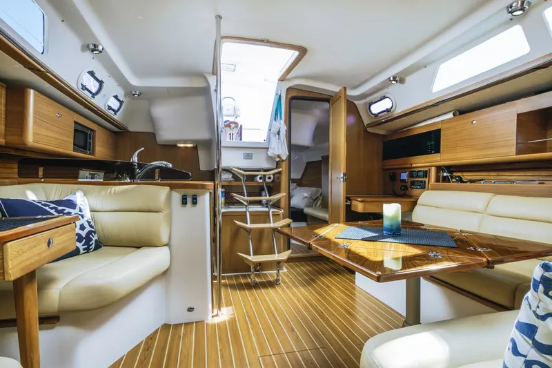 Kia Ora Yacht Photos Pics Interior of 2014 Catalina 385 sailboat with modern wood finish and comfortable seating.