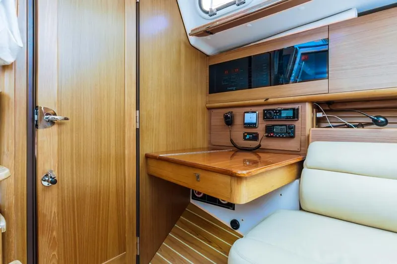 Kia Ora Yacht Photos Pics Catalina 385 yacht interior, 2014 model, featuring navigation equipment and wooden cabinetry.
