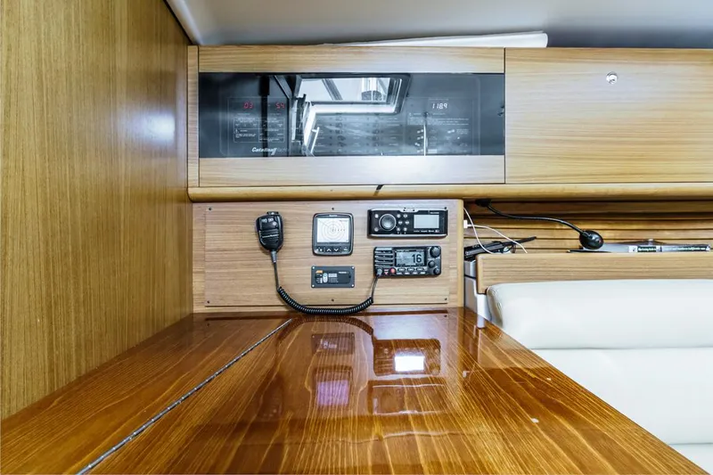 Kia Ora Yacht Photos Pics Interior of 2014 Catalina 385 yacht with navigation equipment and wooden finish.