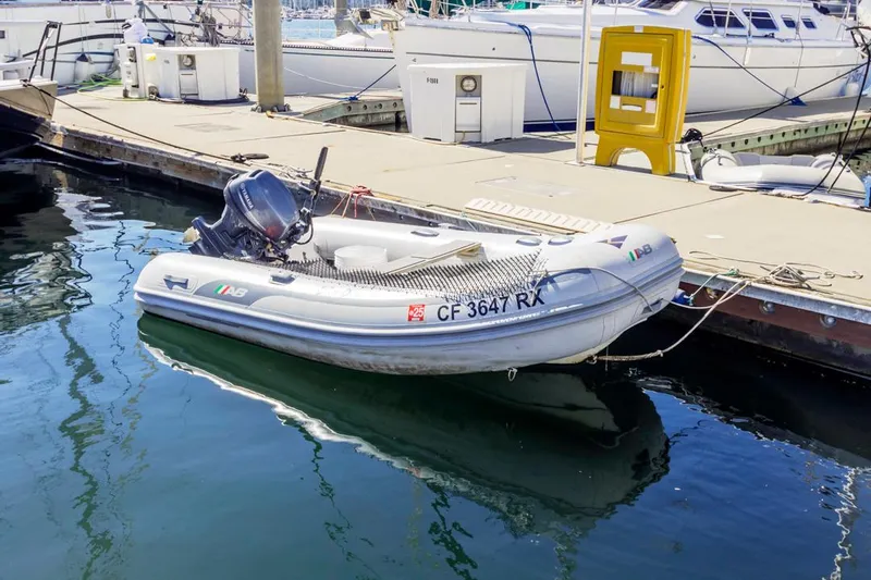 Kia Ora Yacht Photos Pics Inflatable boat docked at marina, near a 2014 Catalina 385 yacht.