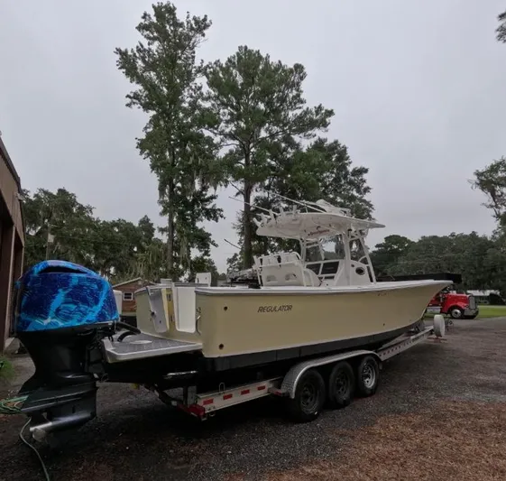  Yacht Photos Pics 2013 Regulator 34 Center Console boat on trailer, parked outdoors.