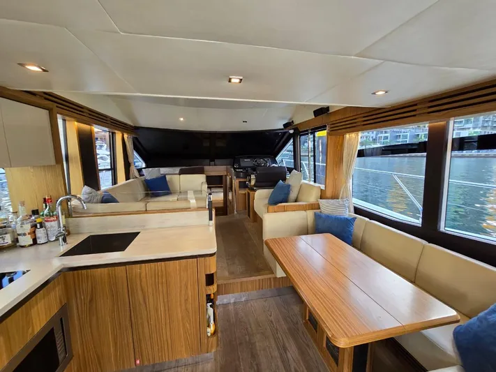  Yacht Photos Pics Luxurious interior of 2015 Absolute 56 FLY yacht with modern kitchen and seating area.