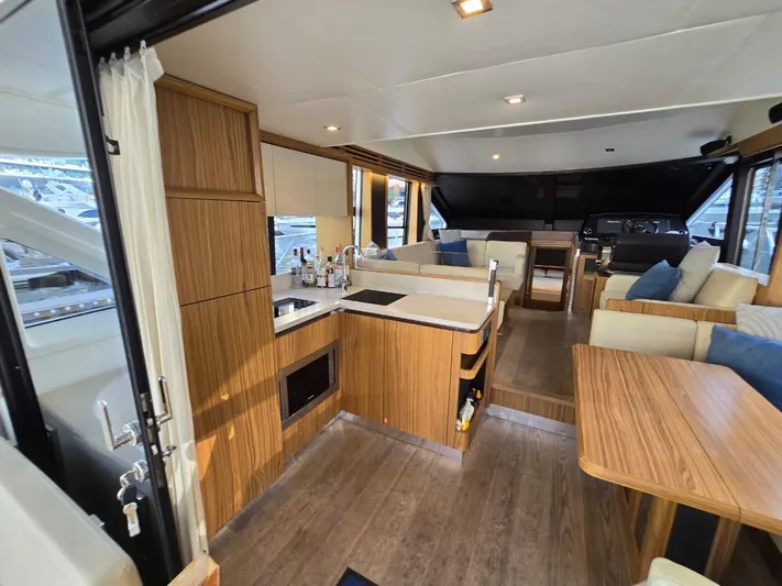  Yacht Photos Pics Luxurious interior of 2015 Absolute 56 FLY yacht with modern kitchen and seating area.