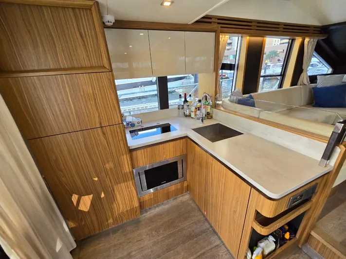  Yacht Photos Pics Luxurious kitchen interior of 2015 Absolute 56 FLY yacht with modern amenities and wood finish.