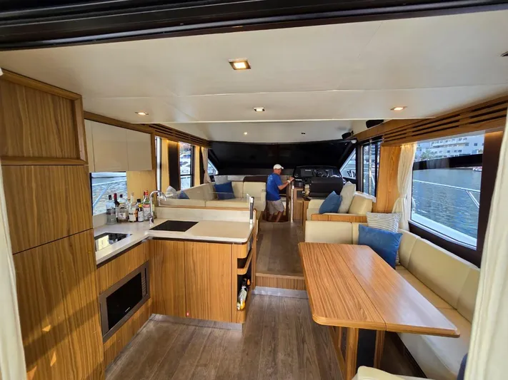  Yacht Photos Pics Luxurious interior of 2015 Absolute 56 FLY yacht with modern kitchen and seating area.