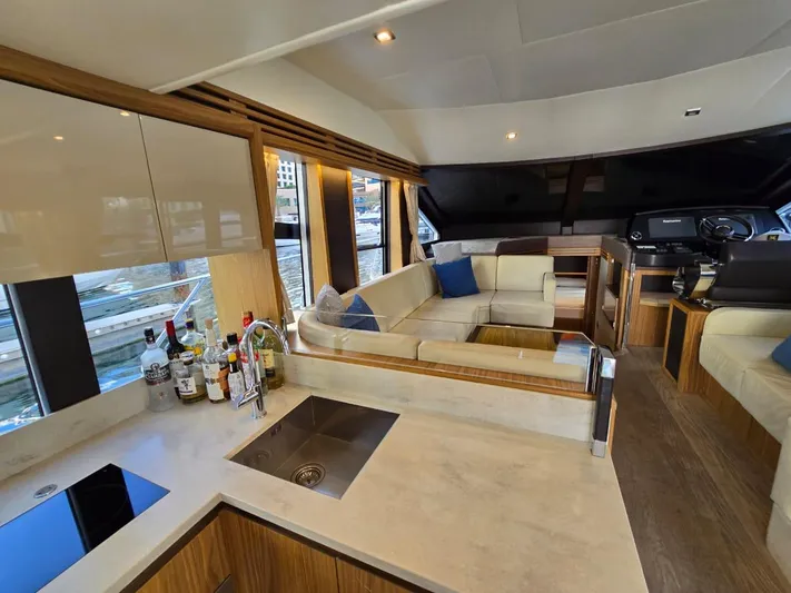  Yacht Photos Pics Luxurious interior of 2015 Absolute 56 FLY yacht with modern kitchen and seating area.