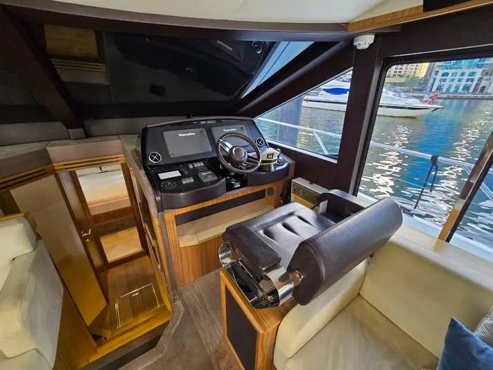  Yacht Photos Pics Luxurious helm of 2015 Absolute 56 FLY yacht with modern controls and waterfront view.