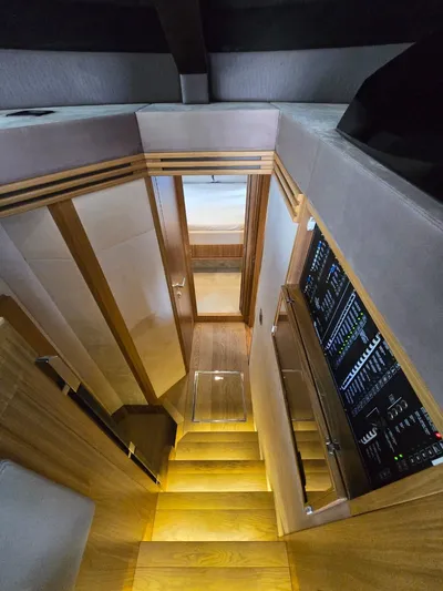  Yacht Photos Pics Interior view of 2015 Absolute 56 FLY yacht, featuring sleek wooden stairs and modern control panel.