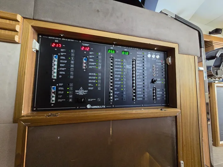  Yacht Photos Pics Control panel of a 2015 Absolute 56 FLY yacht, featuring various switches and indicators.