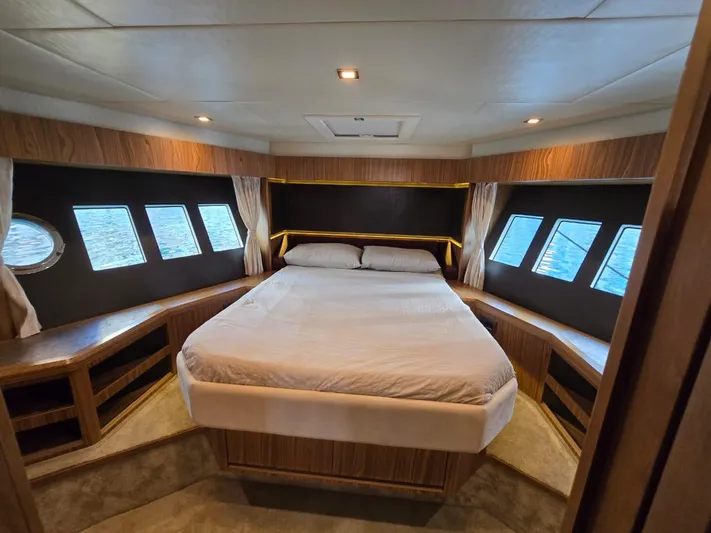  Yacht Photos Pics Luxurious bedroom interior of 2015 Absolute 56 FLY yacht with panoramic windows.