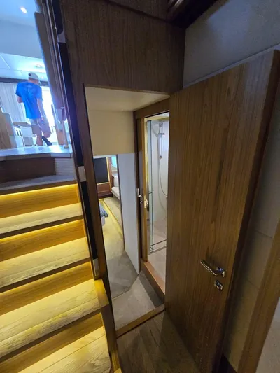  Yacht Photos Pics Interior of 2015 Absolute 56 FLY yacht with wooden stairs and a bathroom.