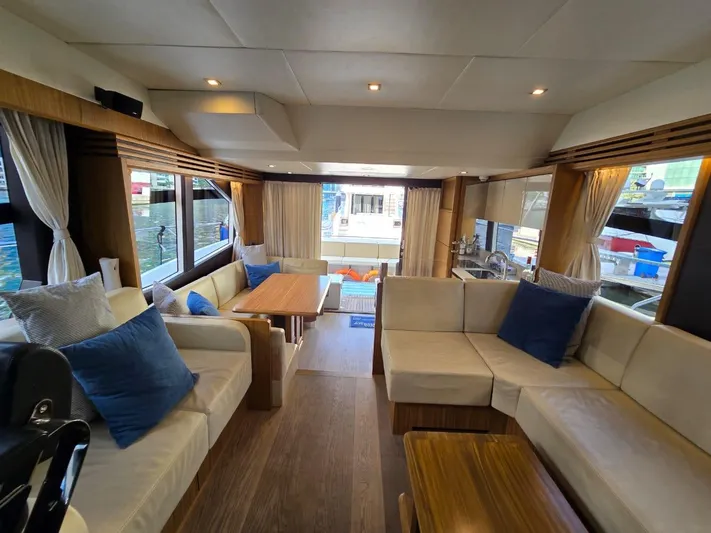  Yacht Photos Pics Luxurious interior of 2015 Absolute 56 FLY yacht with elegant seating and wooden accents.