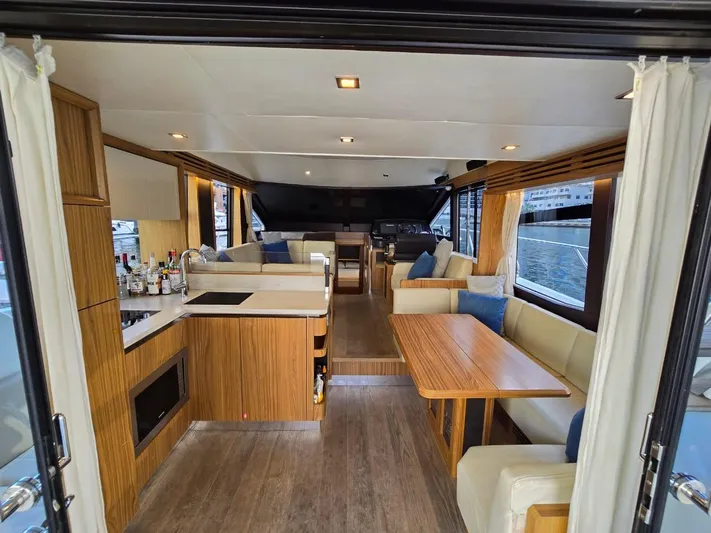  Yacht Photos Pics Luxurious interior of 2015 Absolute 56 FLY yacht with modern kitchen and seating area.