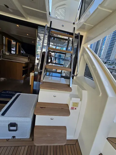  Yacht Photos Pics Interior view of 2015 Absolute 56 FLY yacht with wooden stairs and modern design.