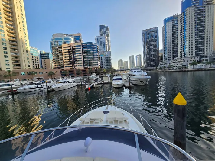  Yacht Photos Pics Absolute 56 FLY yacht in a marina with modern skyscrapers, 2015 model.