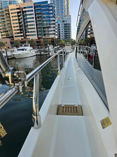  Yacht Photos Pics Side view of 2015 Absolute 56 FLY yacht docked in a marina.