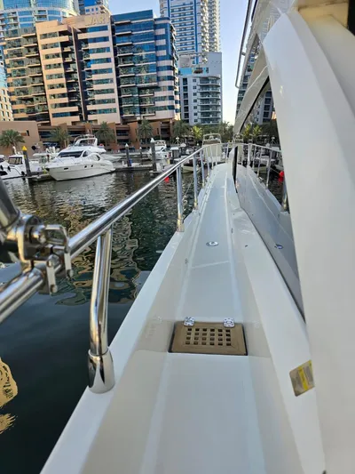  Yacht Photos Pics Side view of a 2015 Absolute 56 FLY yacht docked in a marina.