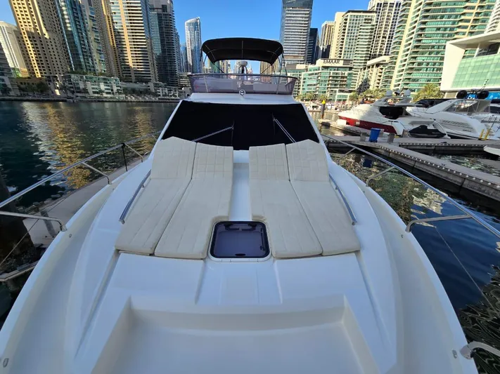  Yacht Photos Pics Luxury Absolute 56 FLY yacht with sun loungers, docked in a modern marina, 2015 model.