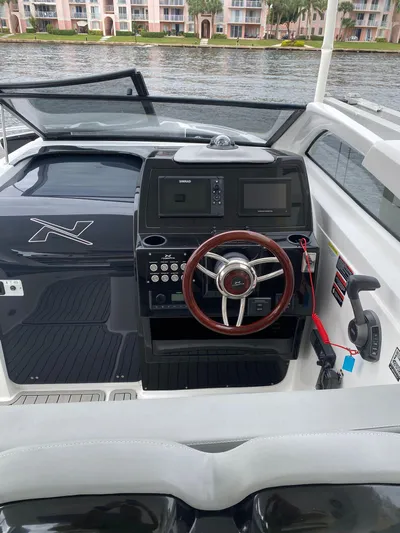  Yacht Photos Pics 2024 NX Boats 280 Xtreme dashboard with steering wheel and control panel.