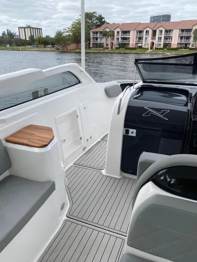  Yacht Photos Pics 2024 NX Boats 280 Xtreme interior with sleek design and waterfront view.