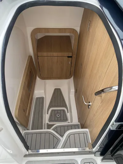  Yacht Photos Pics 2024 NX Boats 280 Xtreme interior with wood accents and modern design.