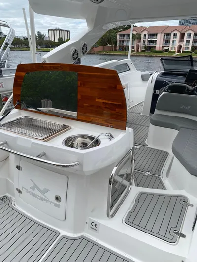  Yacht Photos Pics 2024 NX Boats 280 Xtreme interior with sleek kitchen and seating area.