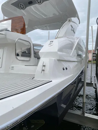  Yacht Photos Pics 2024 NX Boats 280 Xtreme, sleek white design, docked on water.