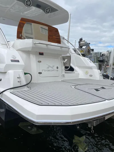  Yacht Photos Pics 2024 NX Boats 280 Xtreme yacht with sleek deck design, docked at marina.
