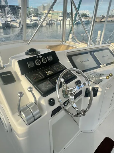  Yacht Photos Pics Control panel of a 2000 Ocean Yachts 48 boat with marina view.