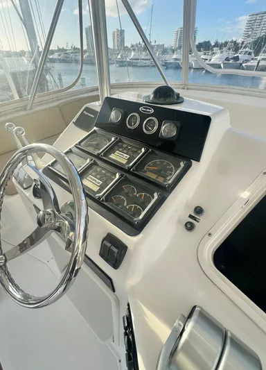 Yacht Photos Pics Helm of 2000 Ocean Yachts 48 with gauges and steering wheel, docked in marina.