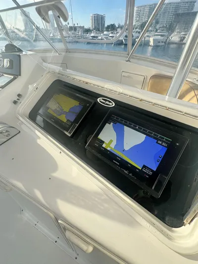  Yacht Photos Pics Ocean Yachts 48 cockpit with navigation screens, marina view, 2000 model.