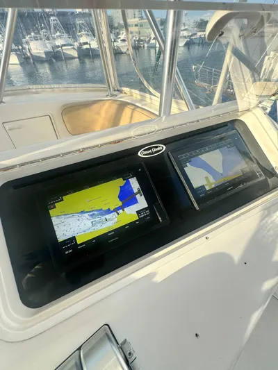  Yacht Photos Pics Ocean Yachts 48 (2000) helm with navigation screens, docked at marina.