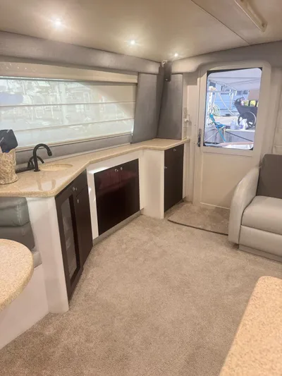  Yacht Photos Pics Luxurious interior of 2000 Ocean Yachts 48, featuring modern kitchen and seating area.