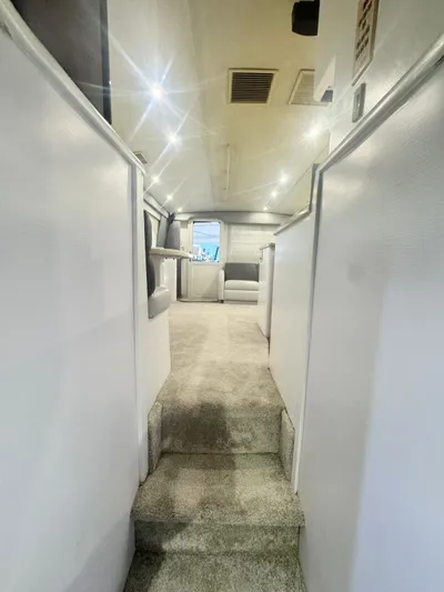  Yacht Photos Pics Interior view of 2000 Ocean Yachts 48, featuring a carpeted hallway and modern lighting.