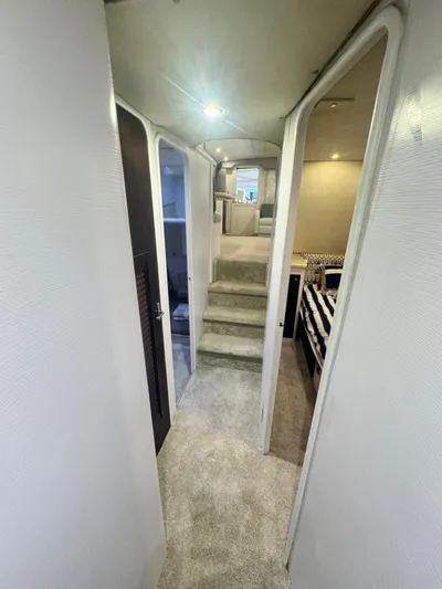  Yacht Photos Pics Interior hallway of 2000 Ocean Yachts 48, featuring carpeted floors and modern design.