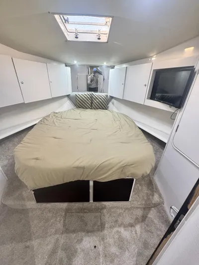  Yacht Photos Pics Interior of 2000 Ocean Yachts 48 with bed, TV, and storage cabinets.