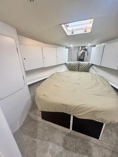  Yacht Photos Pics Interior of 2000 Ocean Yachts 48, featuring a cozy bedroom with skylight.