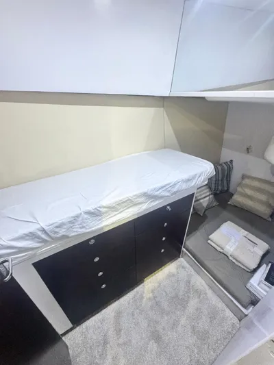  Yacht Photos Pics Interior cabin of 2000 Ocean Yachts 48, featuring a bed, storage, and seating area.