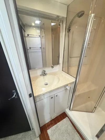  Yacht Photos Pics Bathroom in 2000 Ocean Yachts 48 with shower, sink, and mirror.