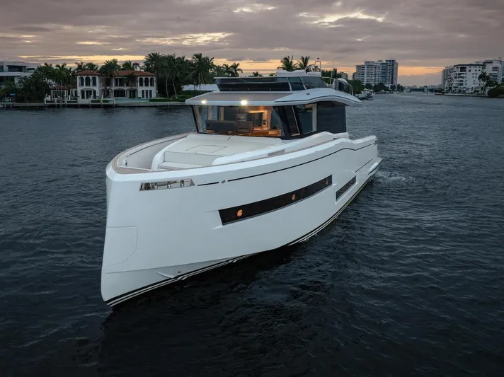  Yacht Photos Pics 2022 Pardo Yachts E60 cruising on a serene waterway at sunset.