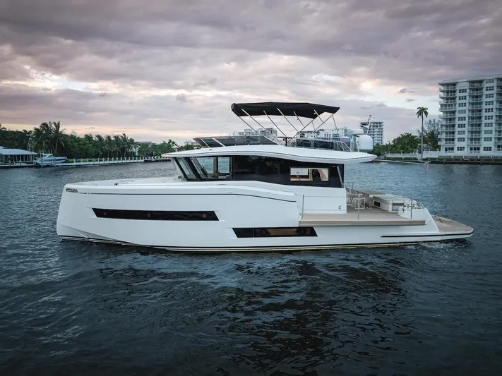  Yacht Photos Pics 2022 Pardo Yachts E60 cruising on a calm waterway at sunset.