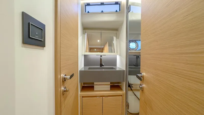  Yacht Photos Pics Modern bathroom interior on 2022 Pardo Yachts E60, featuring sleek sink and wooden cabinetry.
