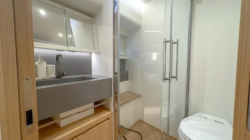  Yacht Photos Pics Luxurious bathroom in 2022 Pardo Yachts E60 with modern fixtures and glass shower.