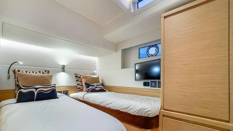  Yacht Photos Pics Luxurious twin cabin in 2022 Pardo Yachts E60, featuring modern design and cozy bedding.